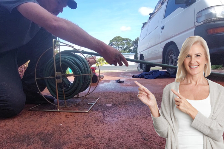 
Efficiently concluding a day of gutter rinsing, a merimbula specialist winds up the hose.